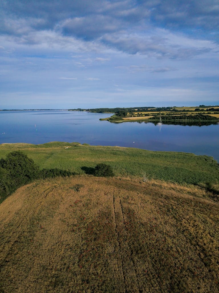 Expansive aerial view of Ørby Hage's serene countryside and riverbanks in Denmark.